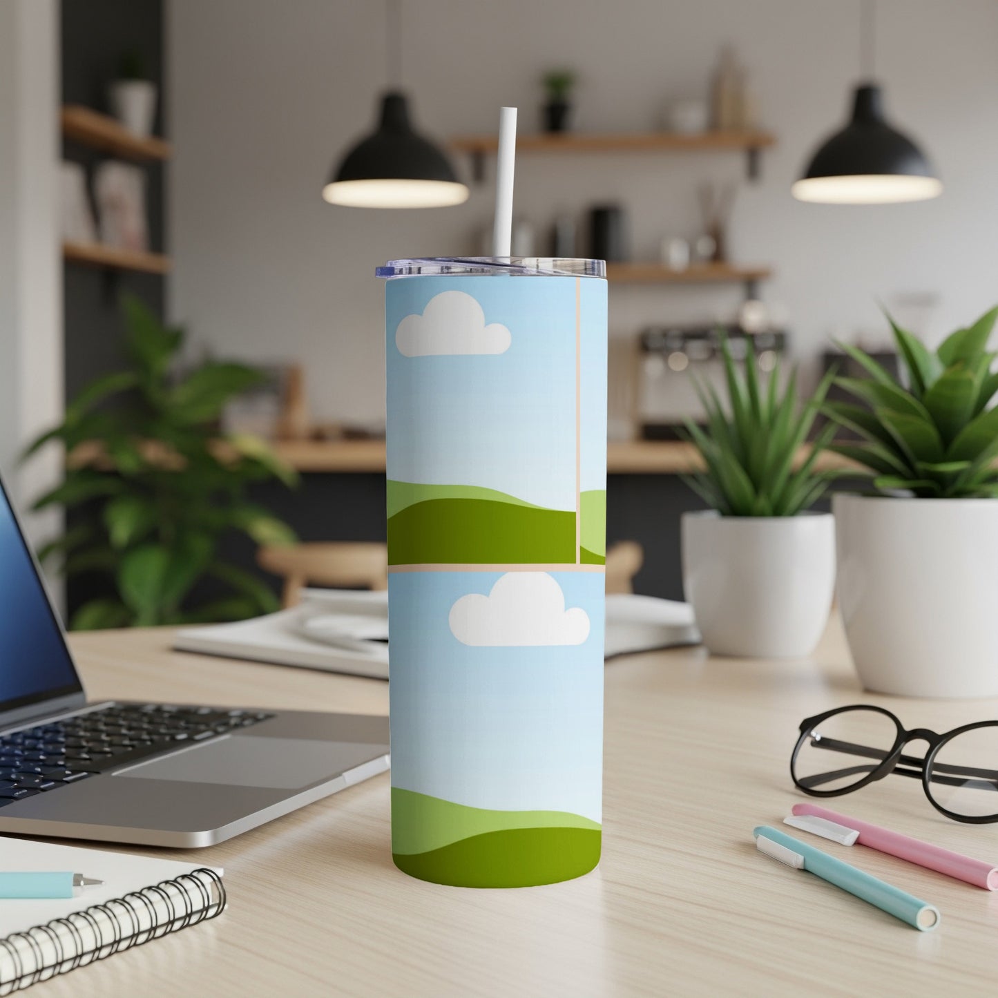 Tall tumbler with a straw and a blue sky and green hills design.