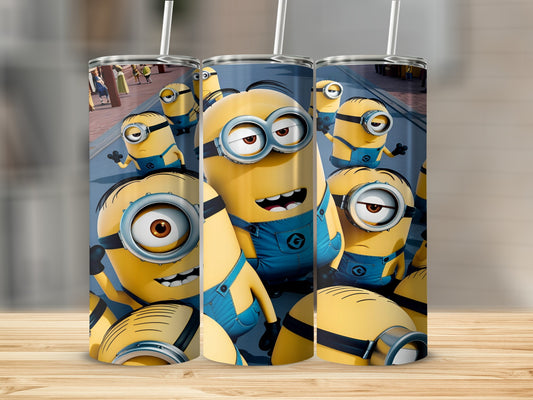 Three Minions characters in blue overalls on a tumbler.