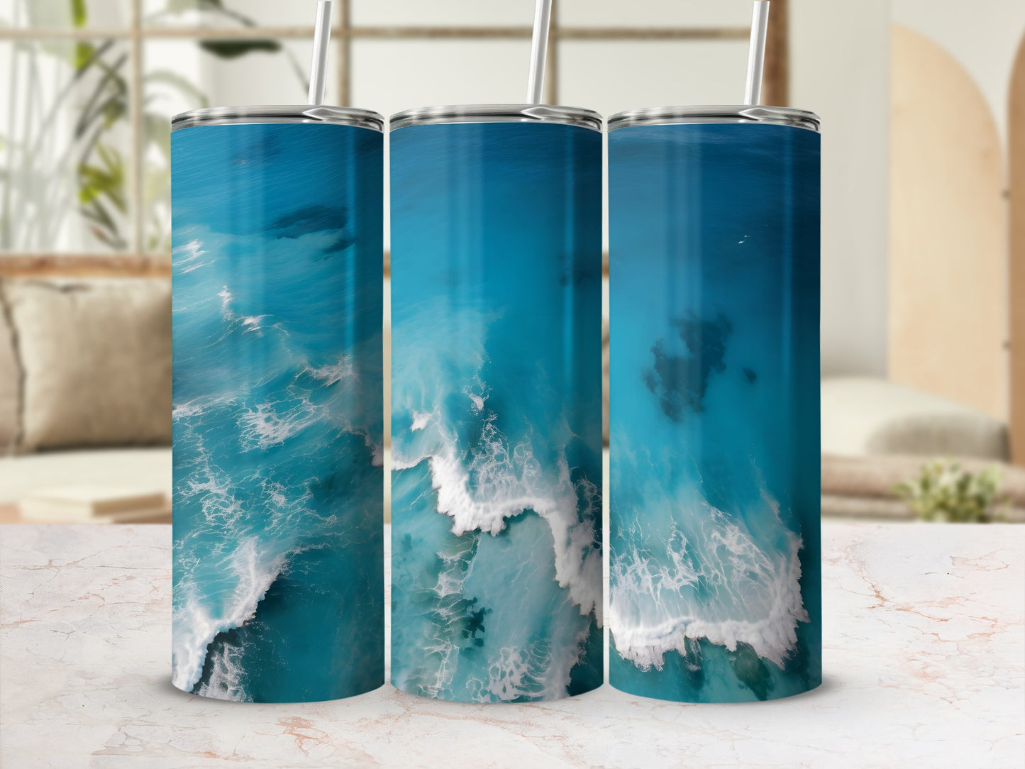 Three tumblers with an aerial view of turquoise ocean waves and white foam.