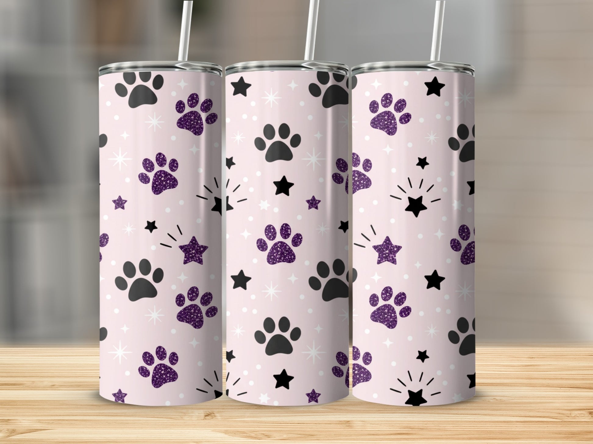 Pink tumbler with paw prints and stars pattern.