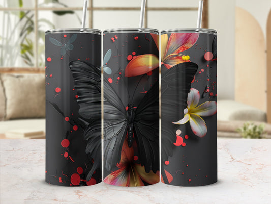 Three tumblers with black butterflies and colorful flowers on a textured dark background.