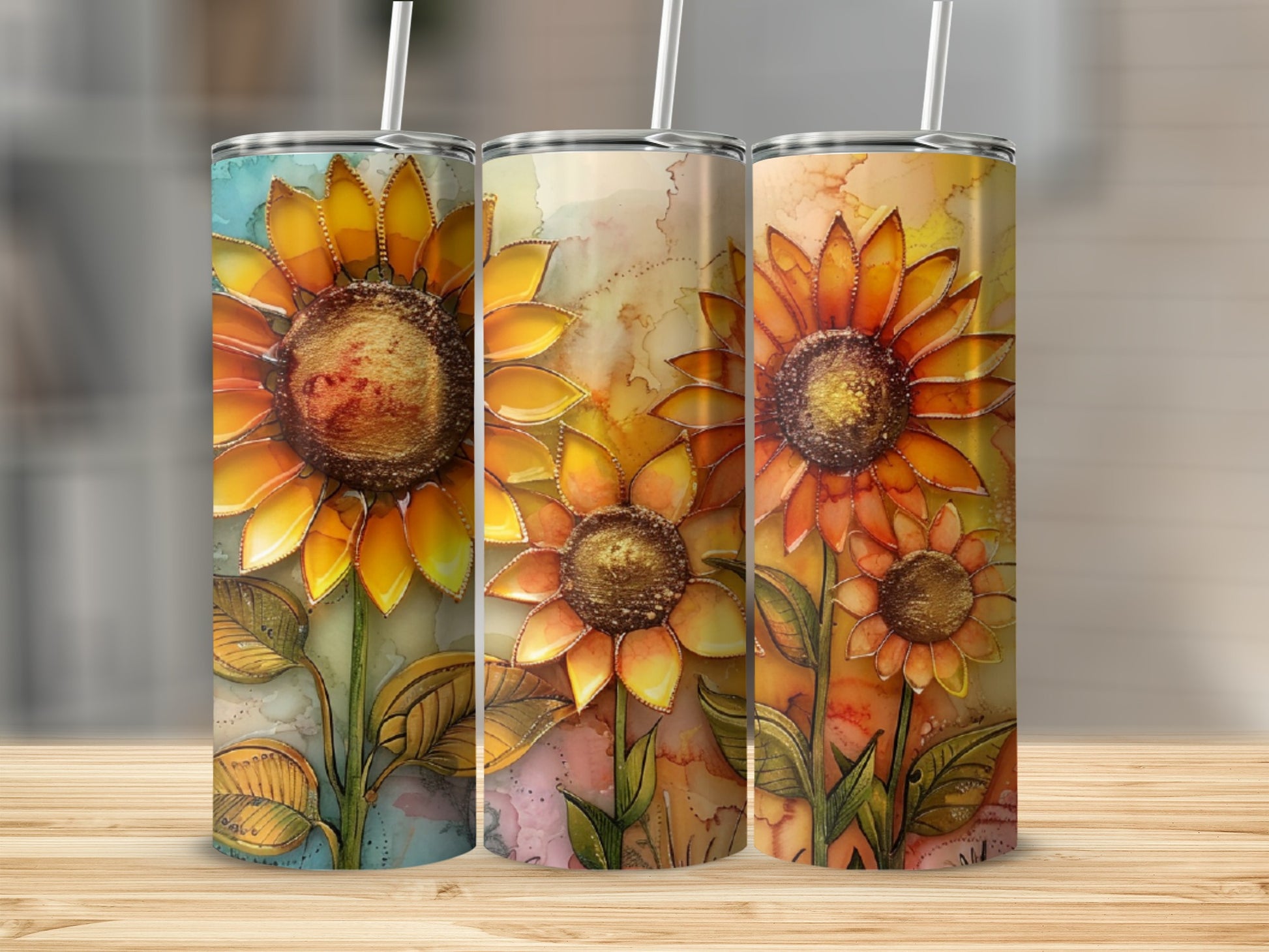 Three tumblers with vibrant sunflower designs in warm, watercolor tones.
