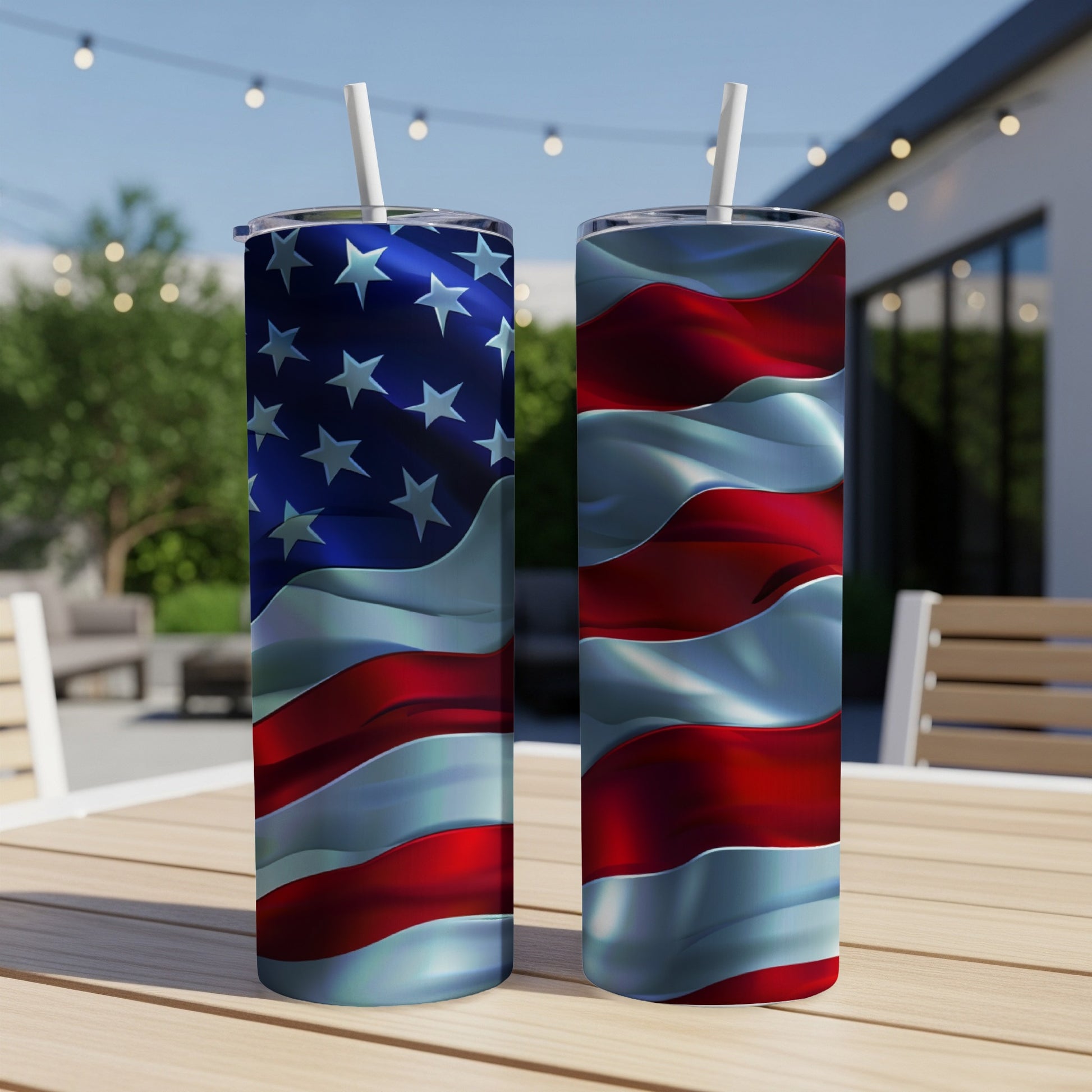 Two tumblers with a US flag design stand on a table outdoors.