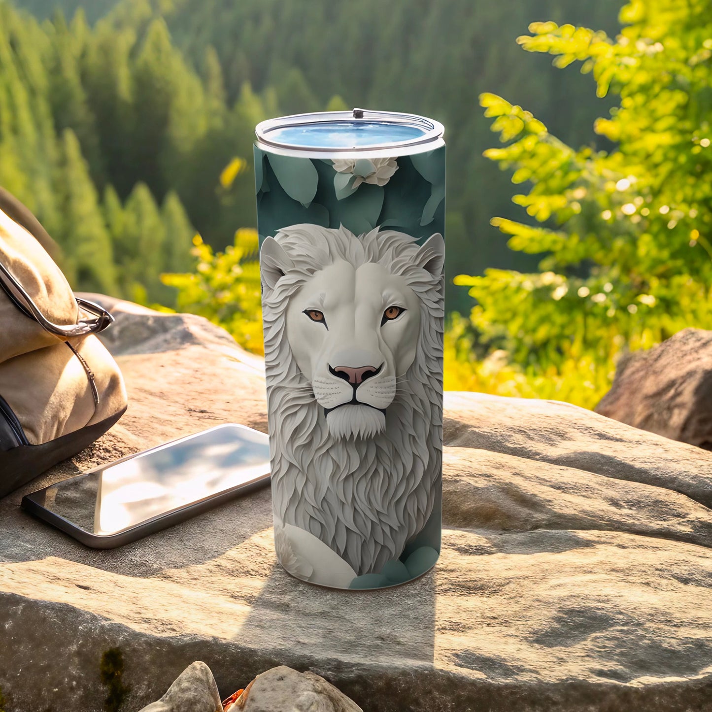 White lion face artwork on a stainless steel tumbler with scenic forest background.