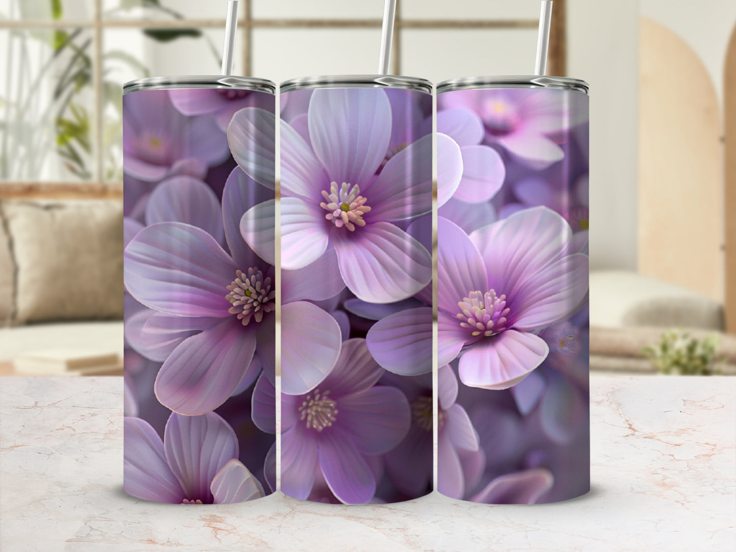 Three purple floral tumblers with straws on a marble surface.