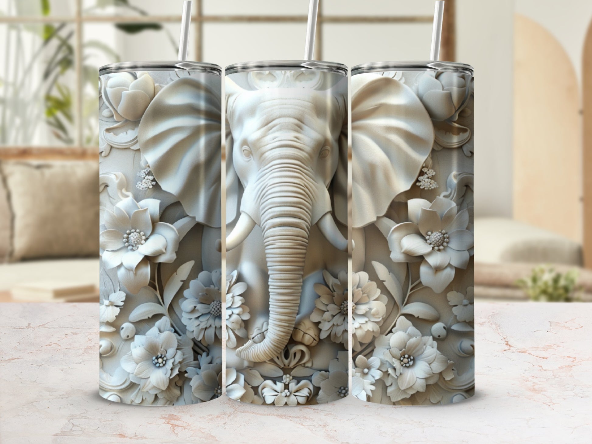 Three tumblers with embossed elephant and floral designs.