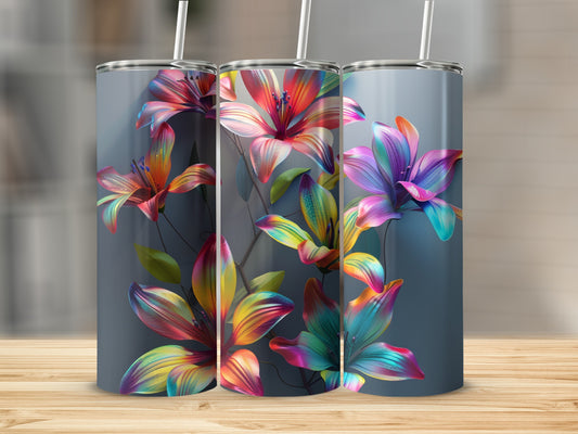 Three tumblers with colorful floral designs arranged on a wooden surface.