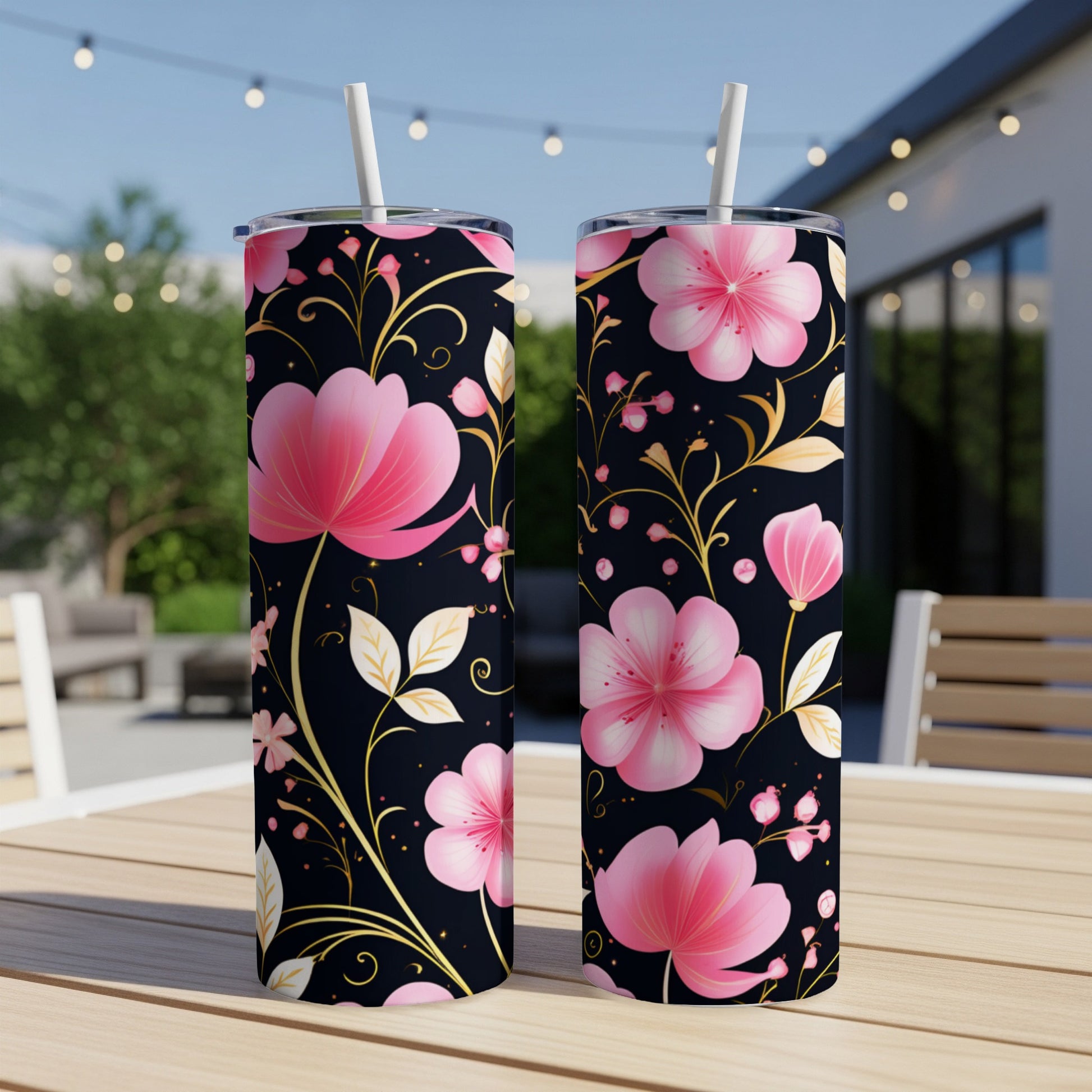Two tall tumblers with pink floral pattern on black background.