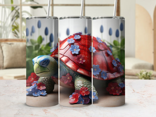 Tumbler with red turtle design adorned with blue and red flowers.