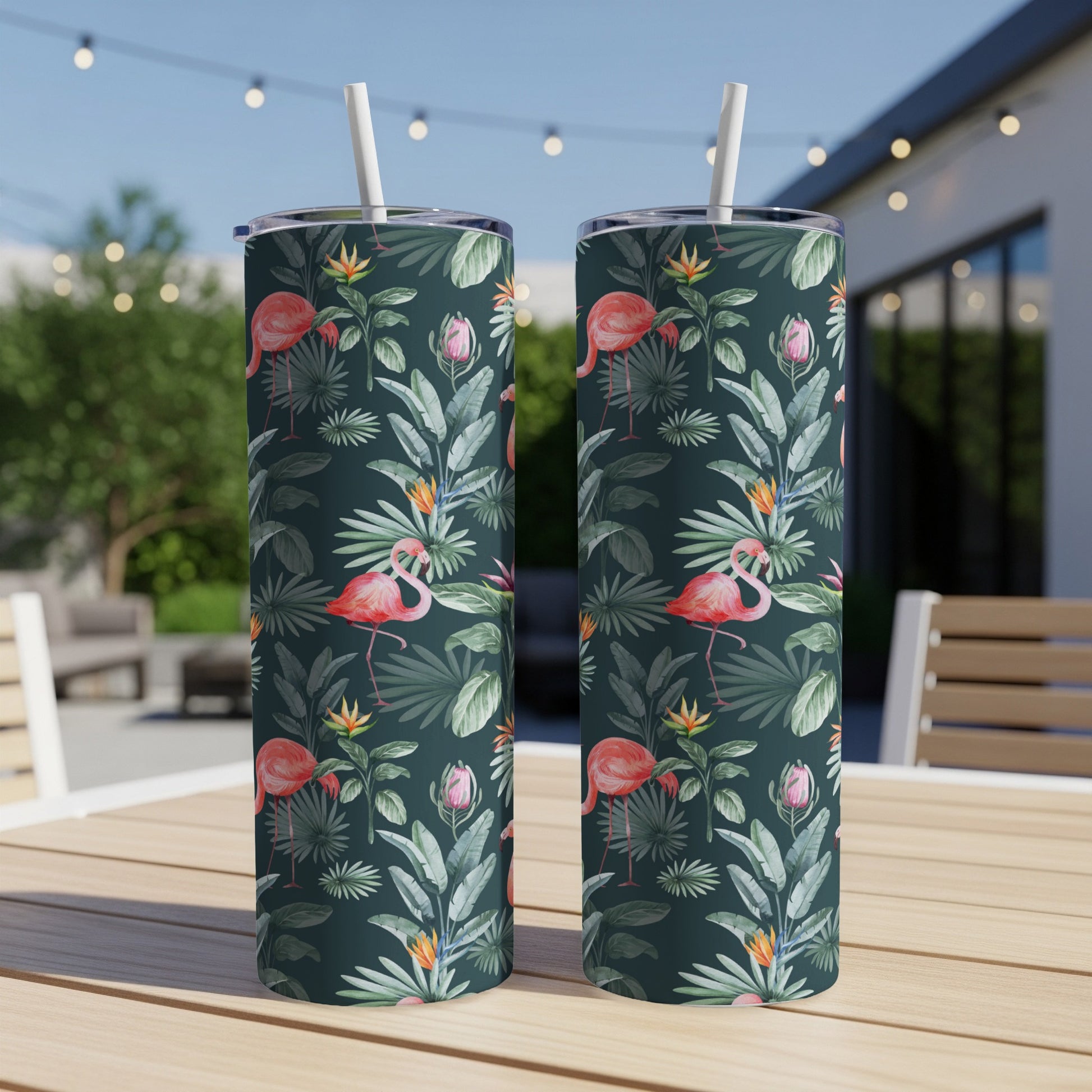 Two pink flamingos on tumblers with tropical floral pattern.