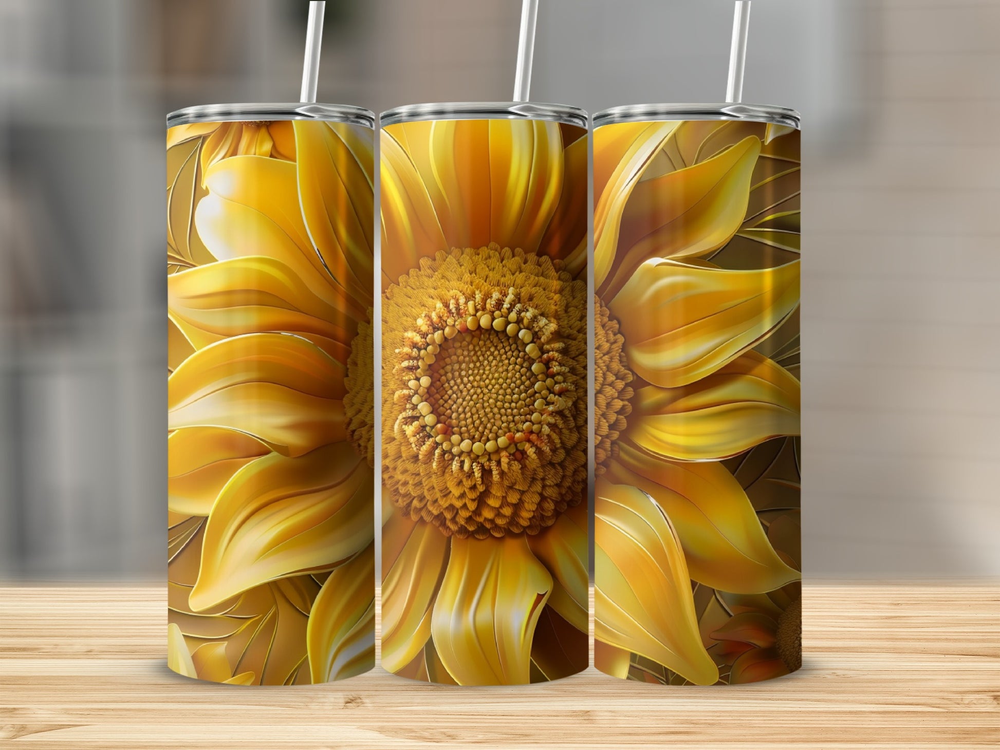 Three tumblers with large yellow sunflower art on a wooden surface.