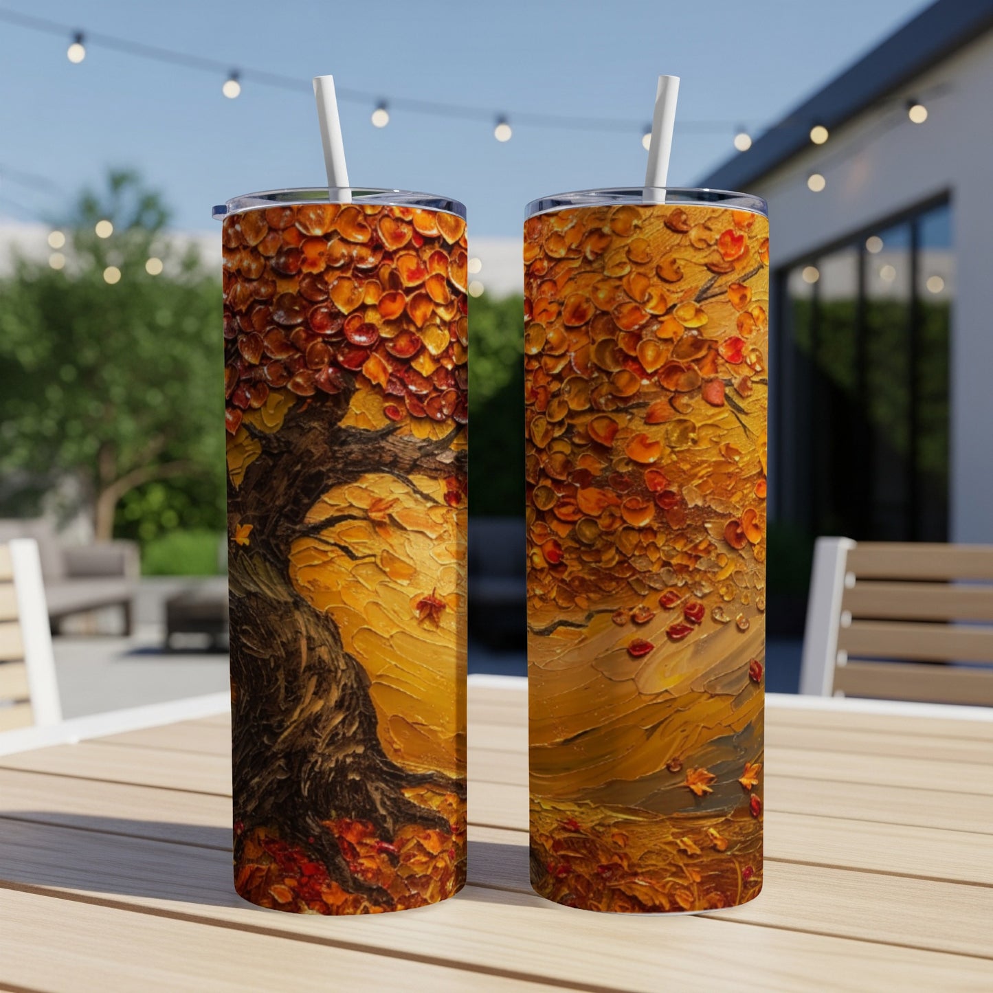 Two tumblers with a vibrant autumn tree and falling leaves design.