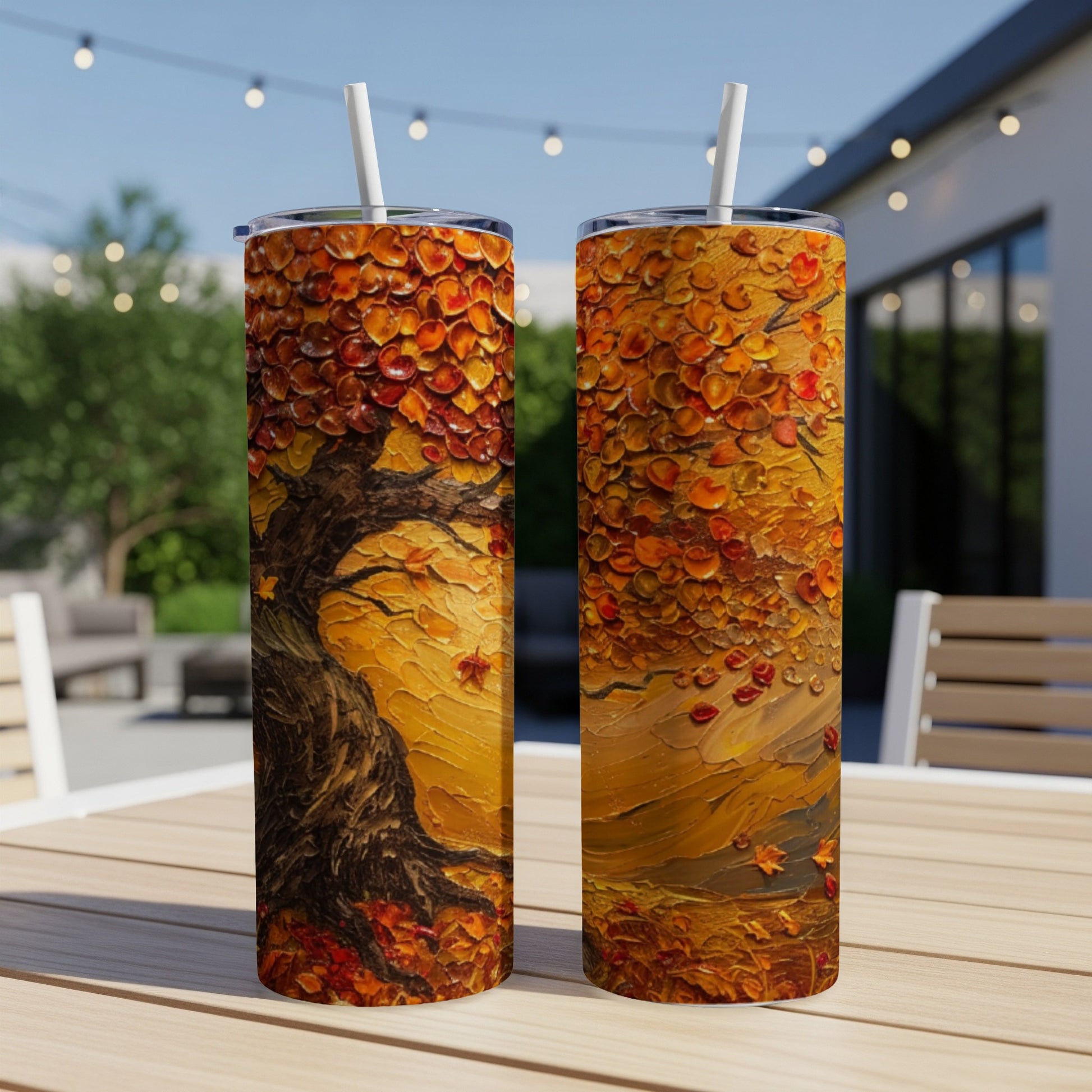 Two tumblers with a vibrant autumn tree and falling leaves design.