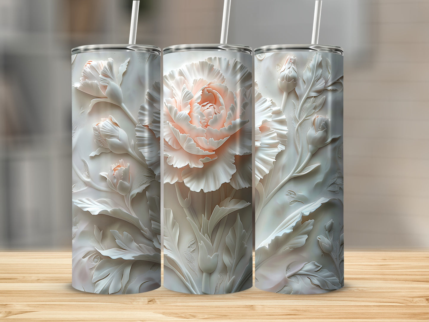 Three tumblers with embossed floral designs, featuring a large pink rose on the center one.