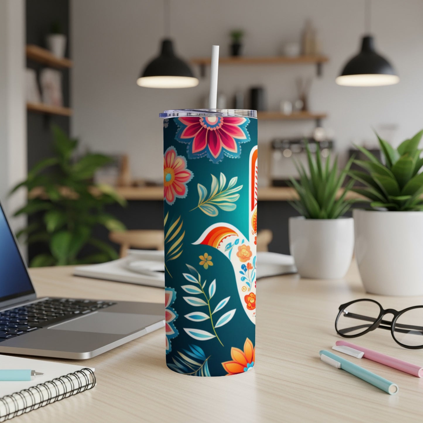 Turquoise tumbler with colorful floral and paisley patterns, featuring a white rabbit design.