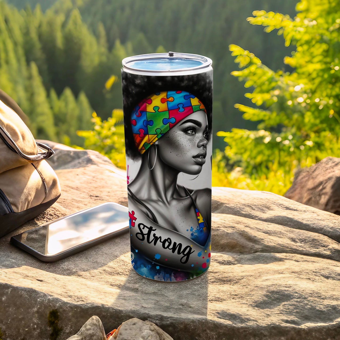 Woman with autism puzzle pattern head wrap, "Strong" text, on tumbler.