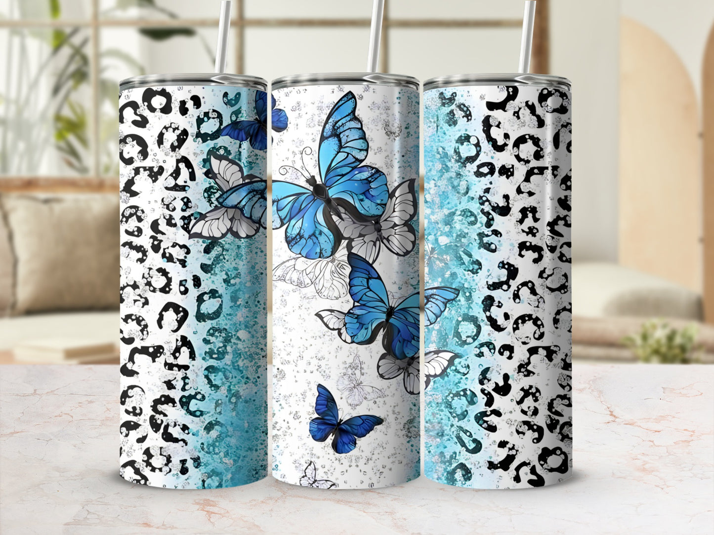 Three tumblers with leopard print and blue butterfly designs.