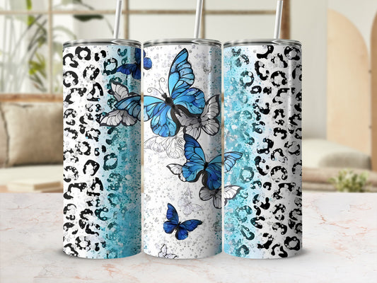 Three tumblers with leopard print and blue butterfly designs.