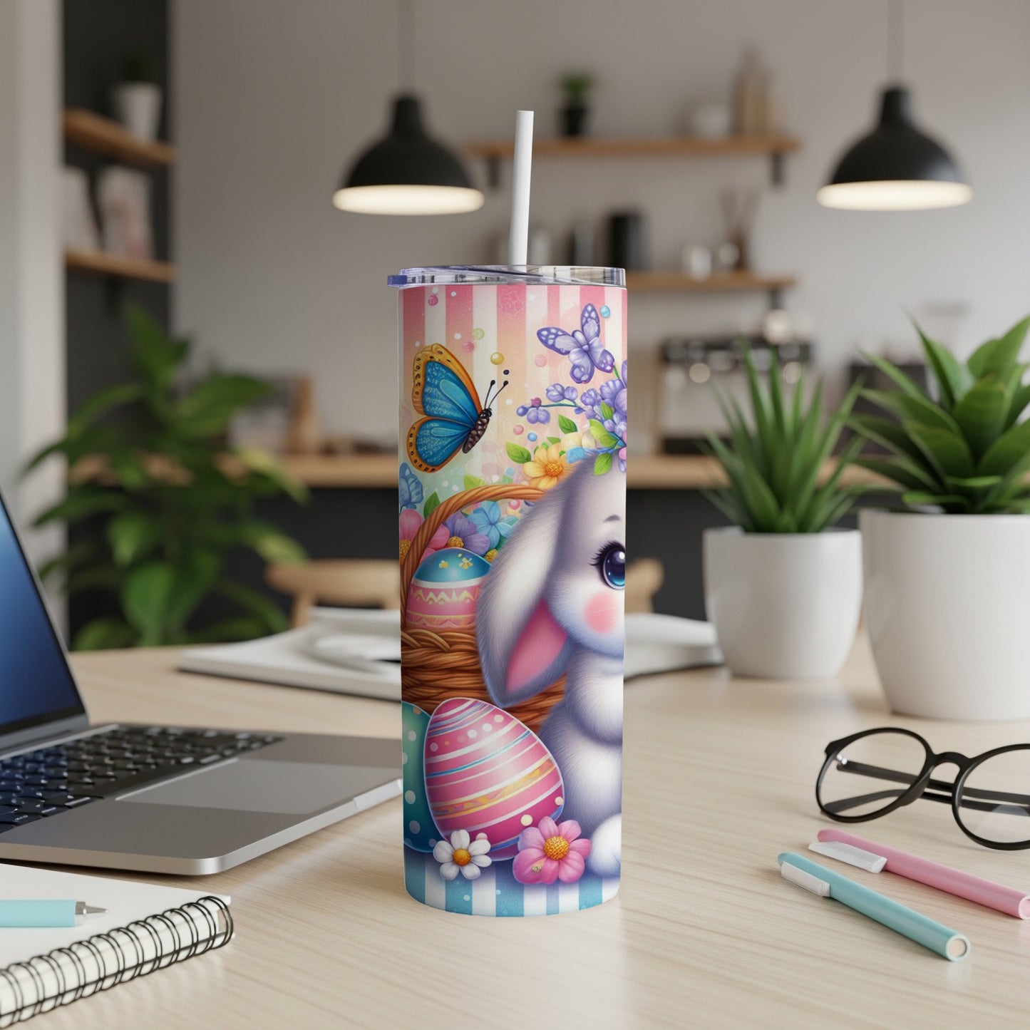 Easter bunny, basket, butterflies, and flowers on a striped tumbler cup.