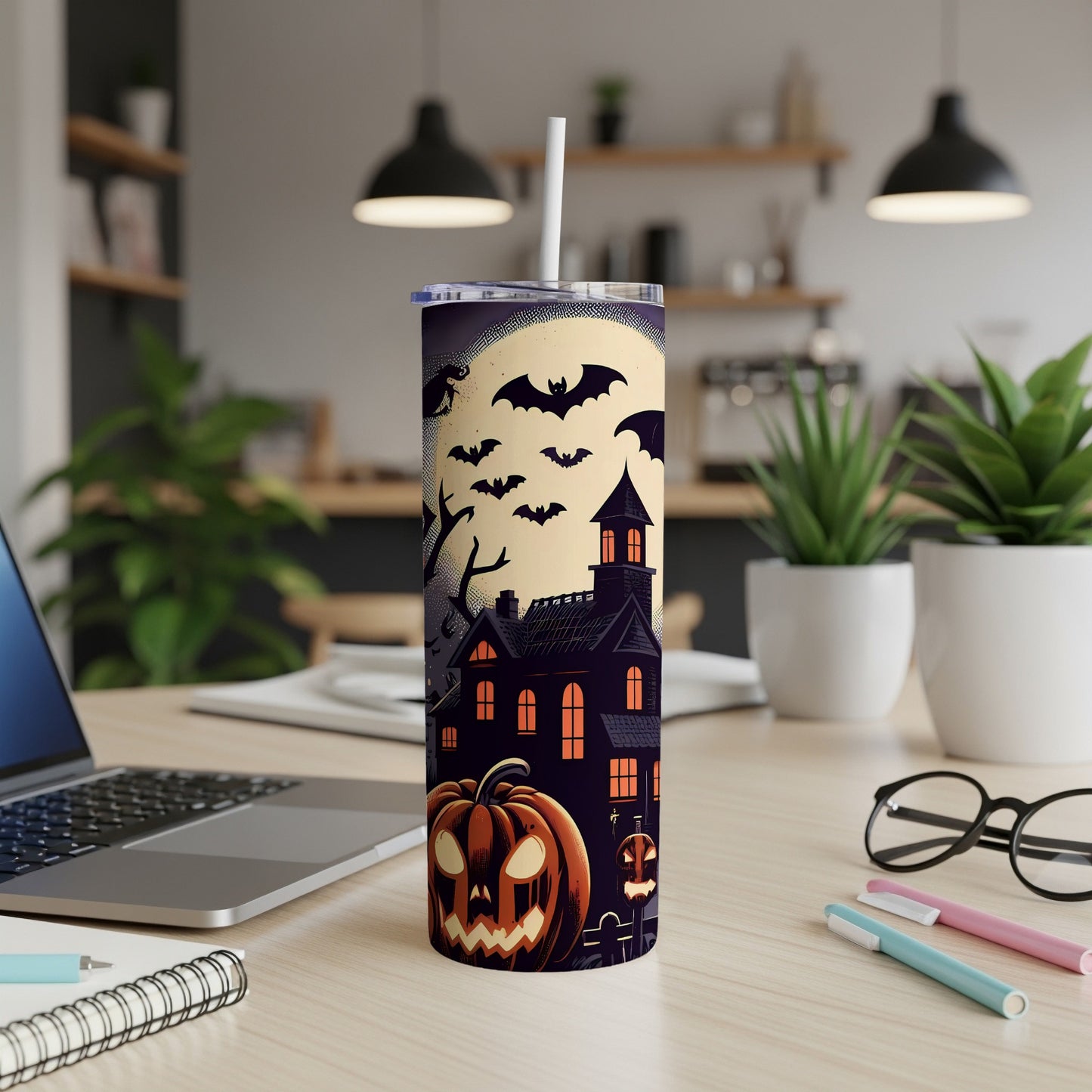 Halloween tumbler with haunted house, bats, and jack-o'-lanterns.