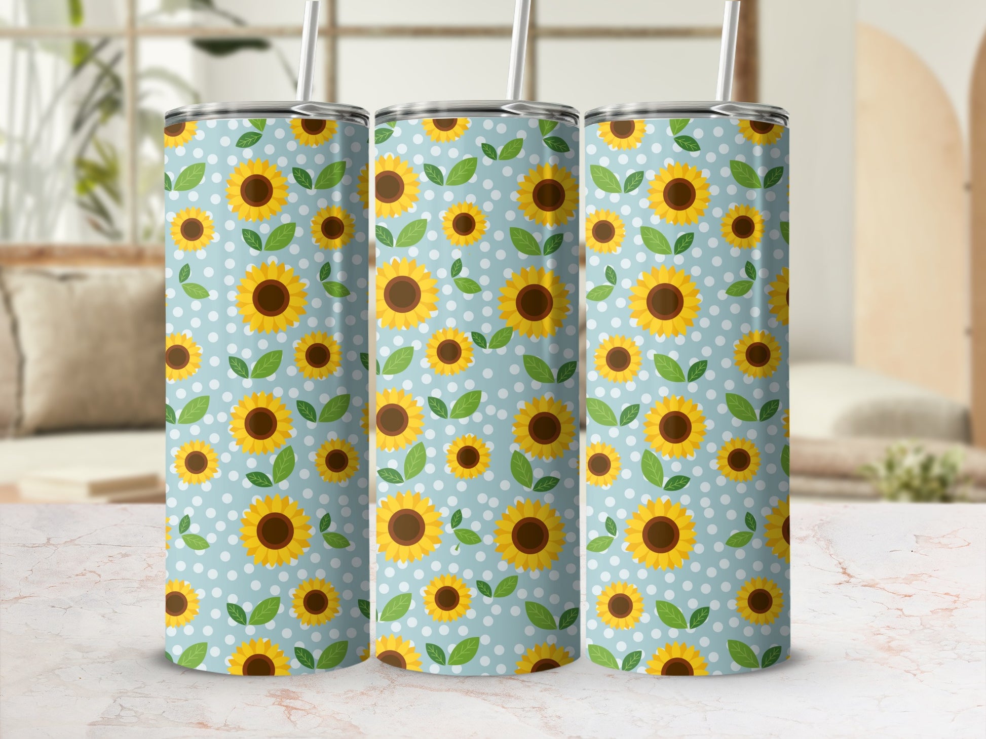 Three tumblers with a blue background and white polka dots, decorated with sunflowers and leaves.