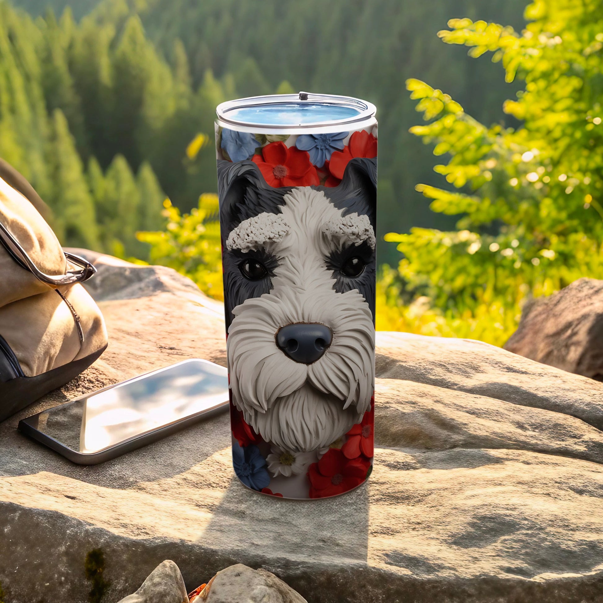 Schnauzer face with floral details on a tumbler outdoors.