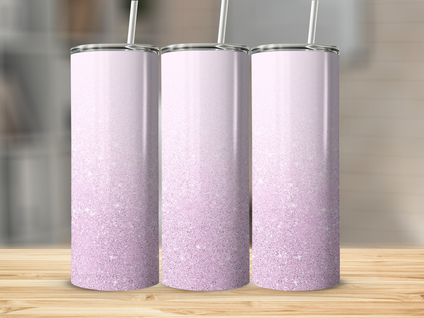 Three tall, slim tumblers with a pink glitter gradient and a straw.