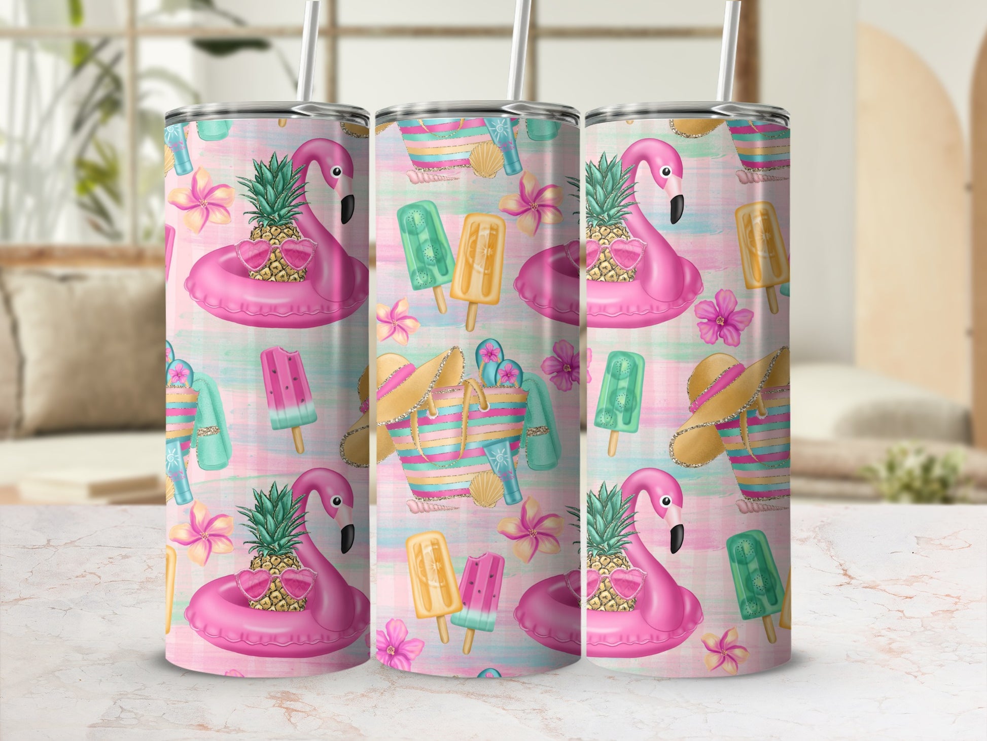 Three tumblers with a pink flamingo, pineapple, and beach-themed pattern.
