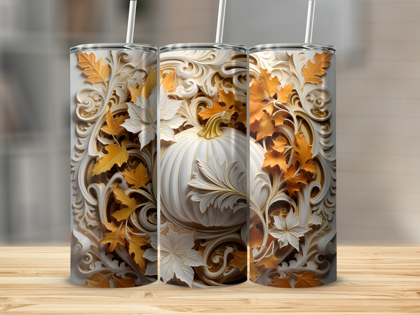 Three white tumblers with embossed autumn leaves and pumpkins on a wooden surface.