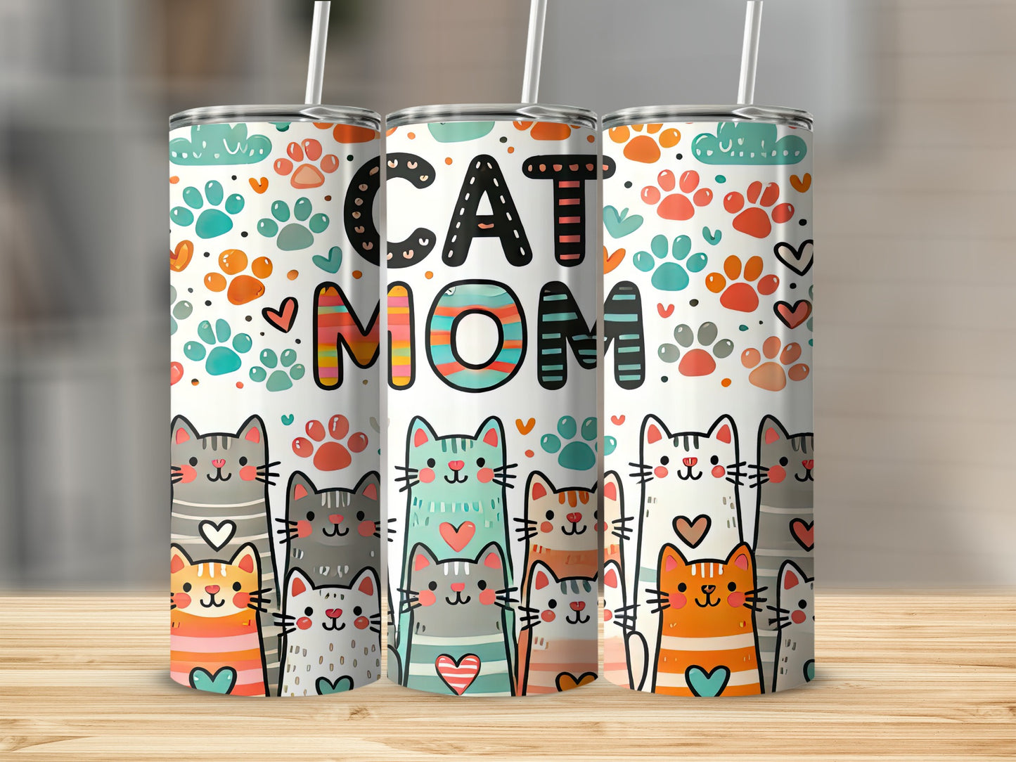 Three cat-themed tumblers with "CAT MOM" text and colorful paw prints.