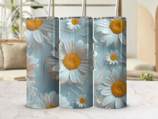 Three tumblers with a daisy flower design on a marbled surface.