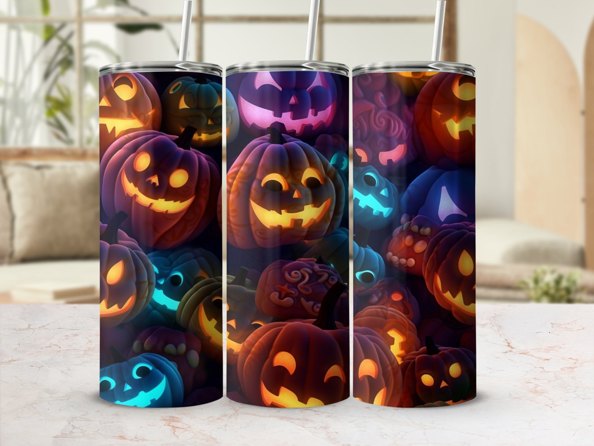 Three tumblers with glowing Halloween pumpkins and straw.