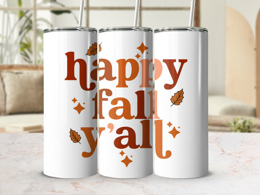 White tumbler with "happy fall y'all" and leaf designs in orange.
