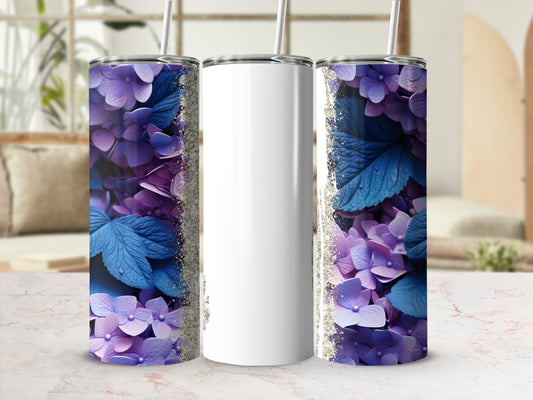 White tumbler with purple floral and blue leaf design and glitter accents.