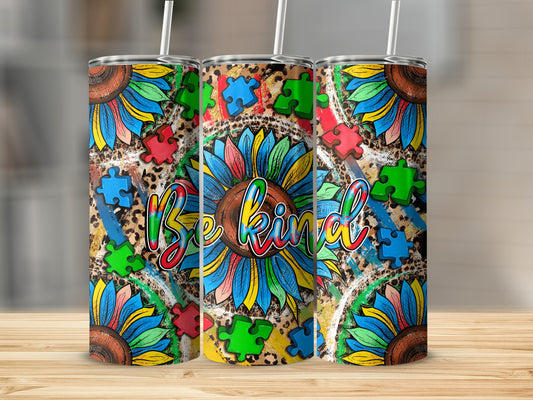 Sunflower and puzzle pieces with "Be kind" text on a tumbler.