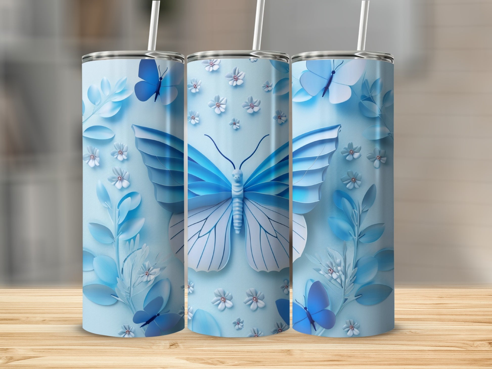 Blue butterfly and floral design on three tumblers.