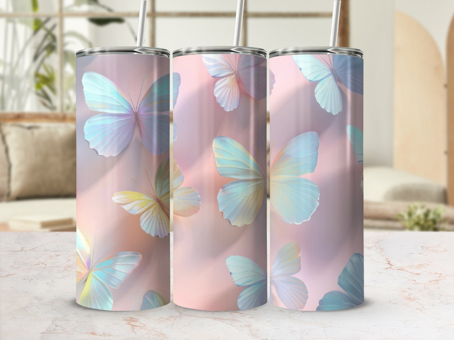 Three tall tumblers with pastel butterfly designs on a pink background.