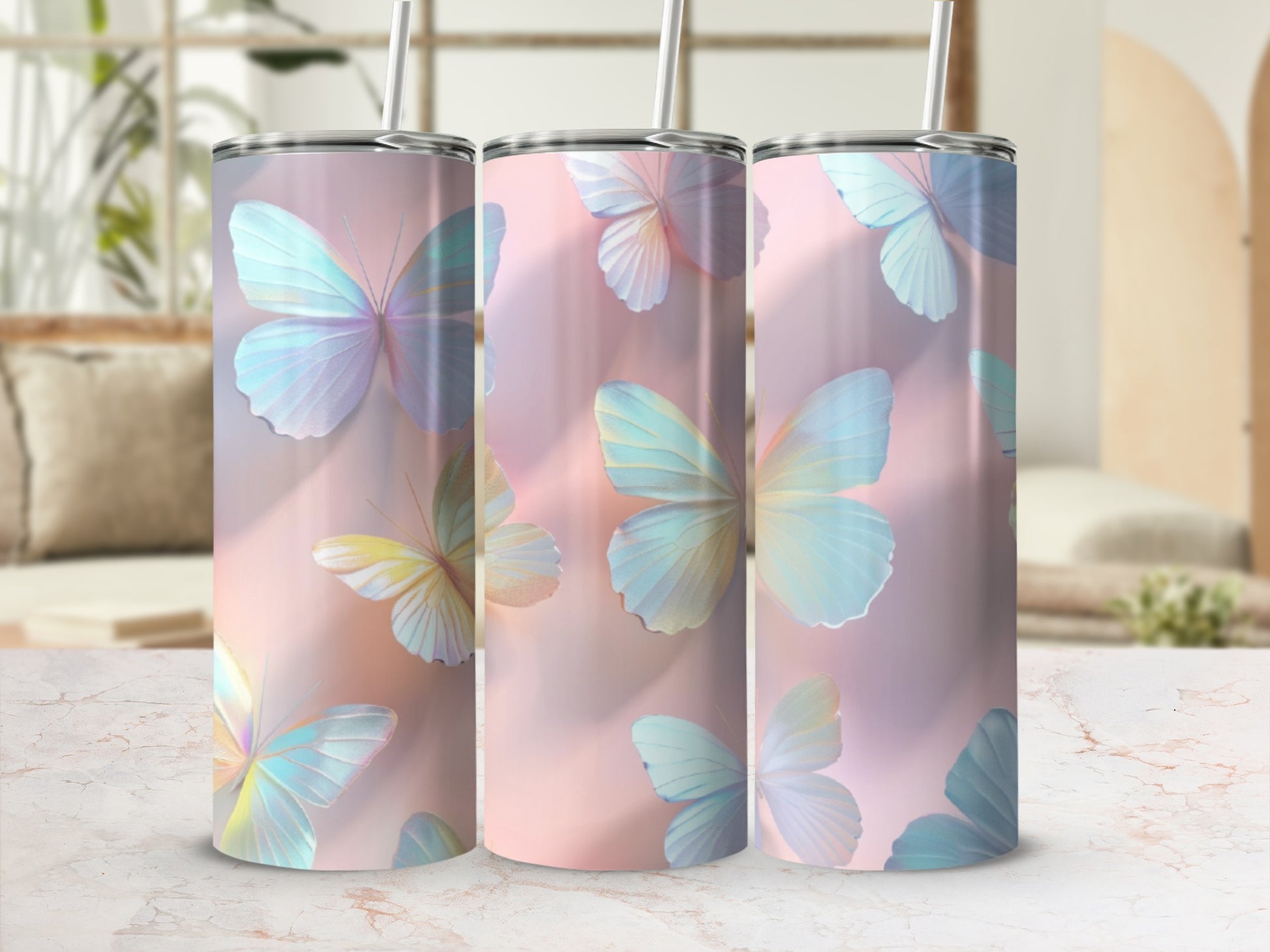 Three tall tumblers with pastel butterfly designs on a pink background.