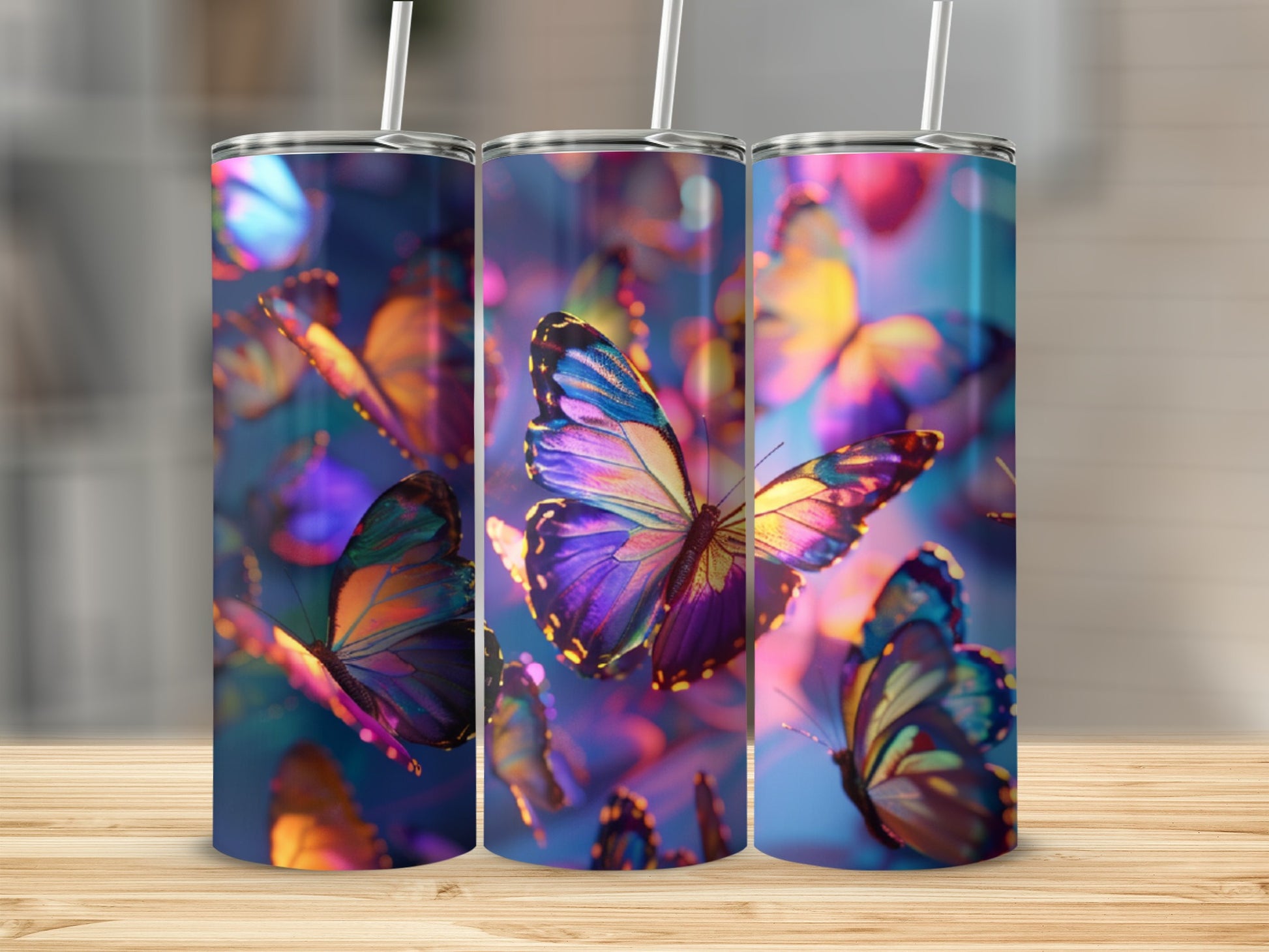 Three tumblers with iridescent butterfly designs, set against a bokeh background.