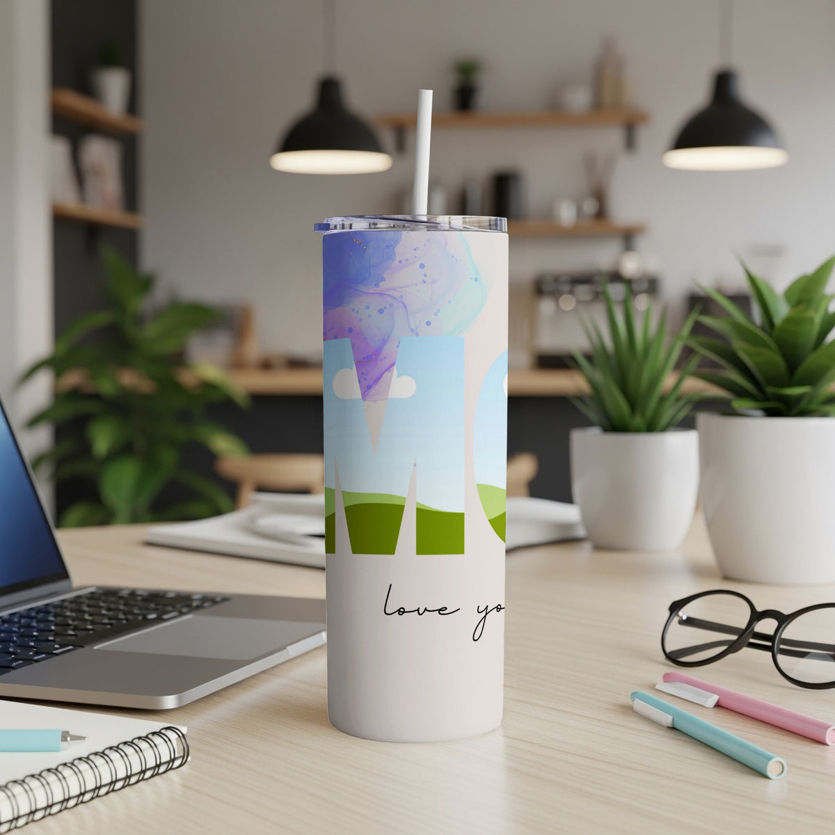 Tumbler with watercolor design and "love you" text on a desk.