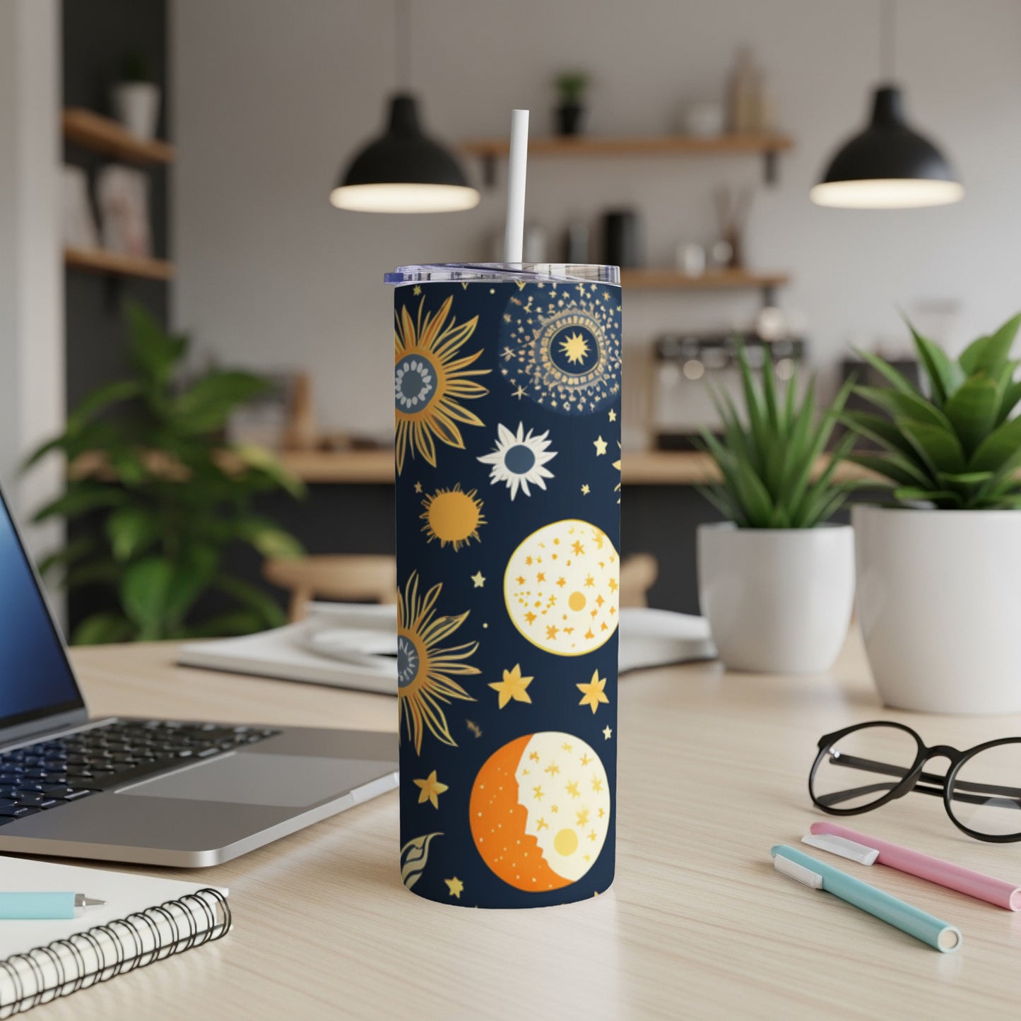 Navy tumbler with sun, moon, and star celestial pattern.