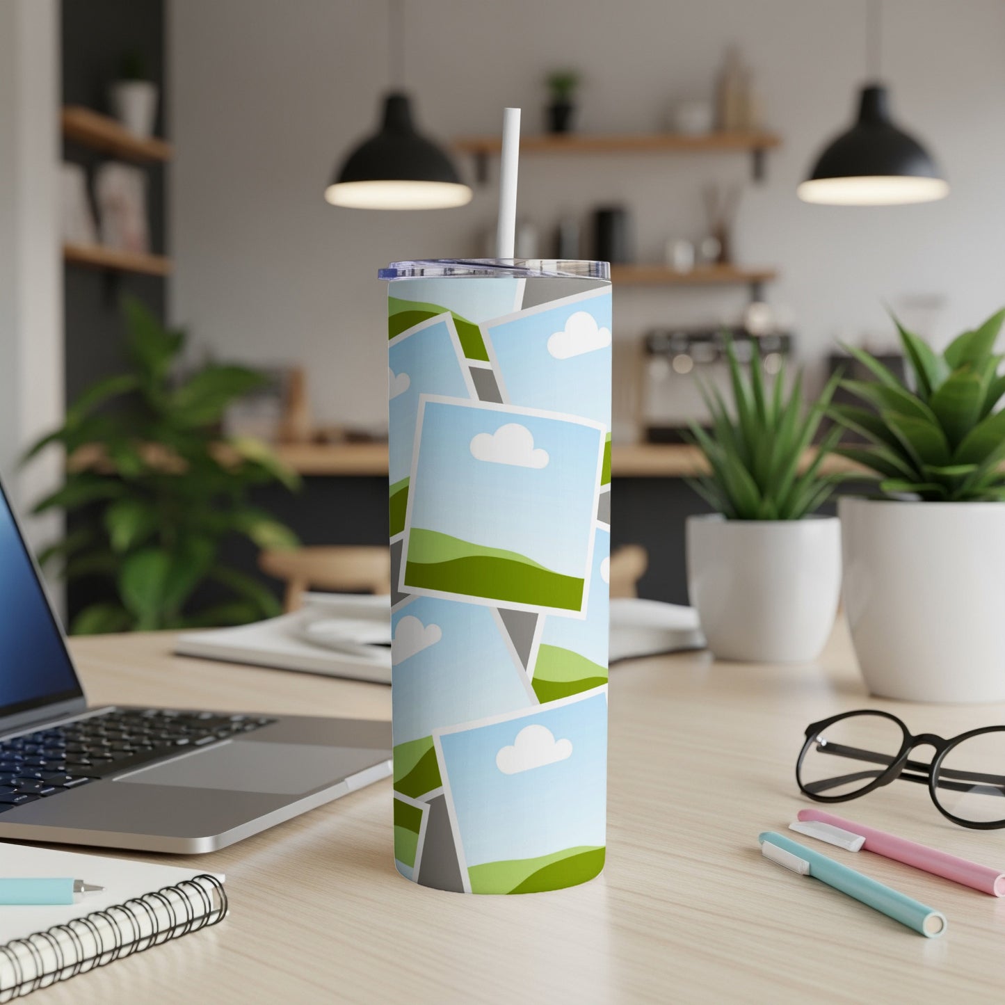 Tall tumbler with a collage of landscape photos and a white straw.
