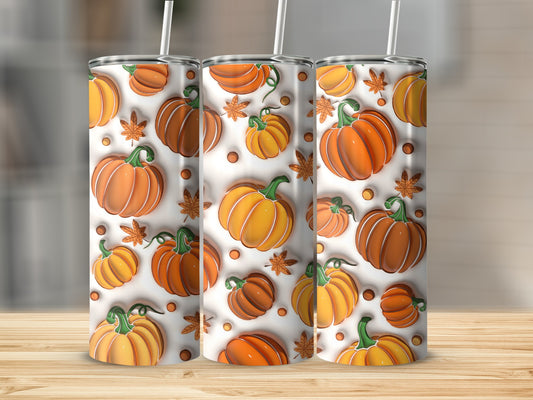 Three tumblers with a repeating pattern of orange pumpkins and green leaves.