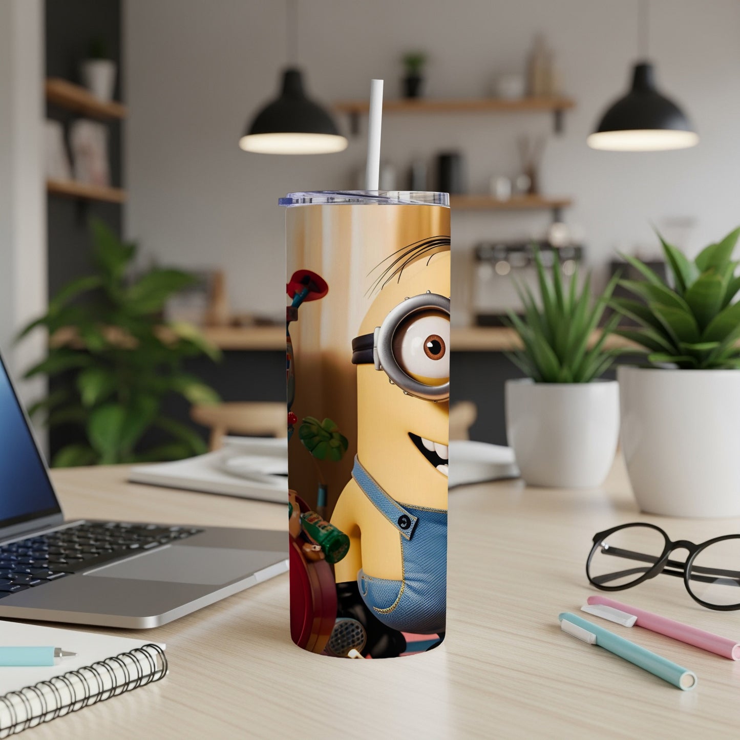 Minion character on a stainless steel tumbler with a straw.