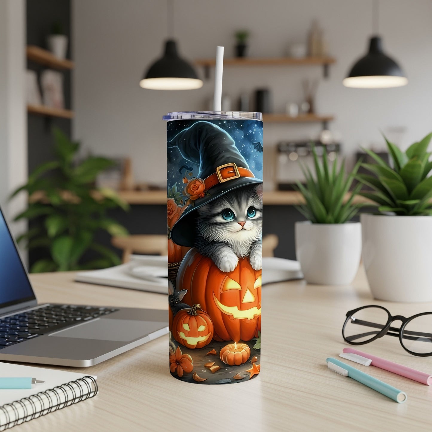 Halloween cat wearing a witch hat sits on a carved pumpkin tumbler.