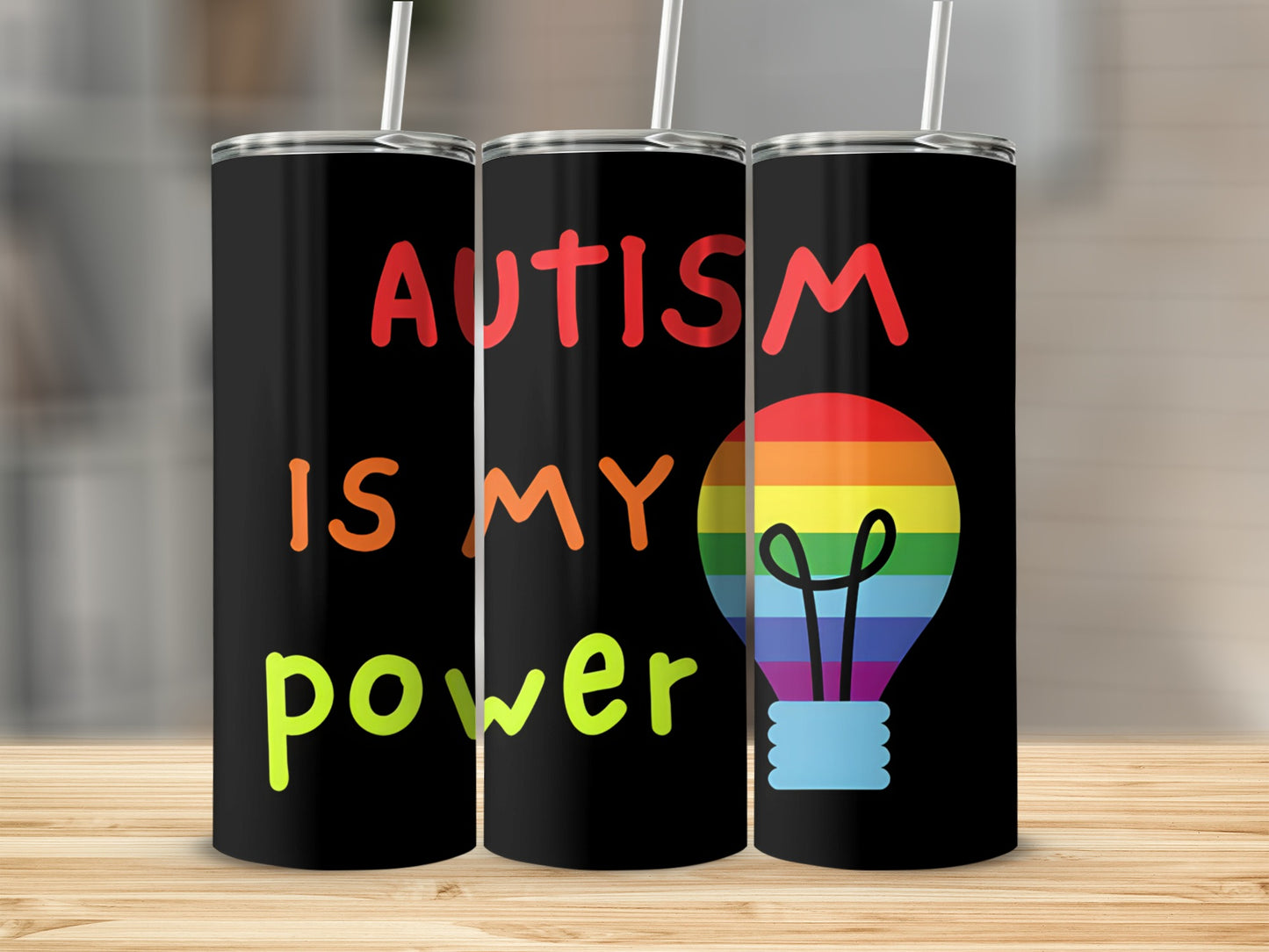 Black tumbler with "Autism is my power" and a rainbow lightbulb.