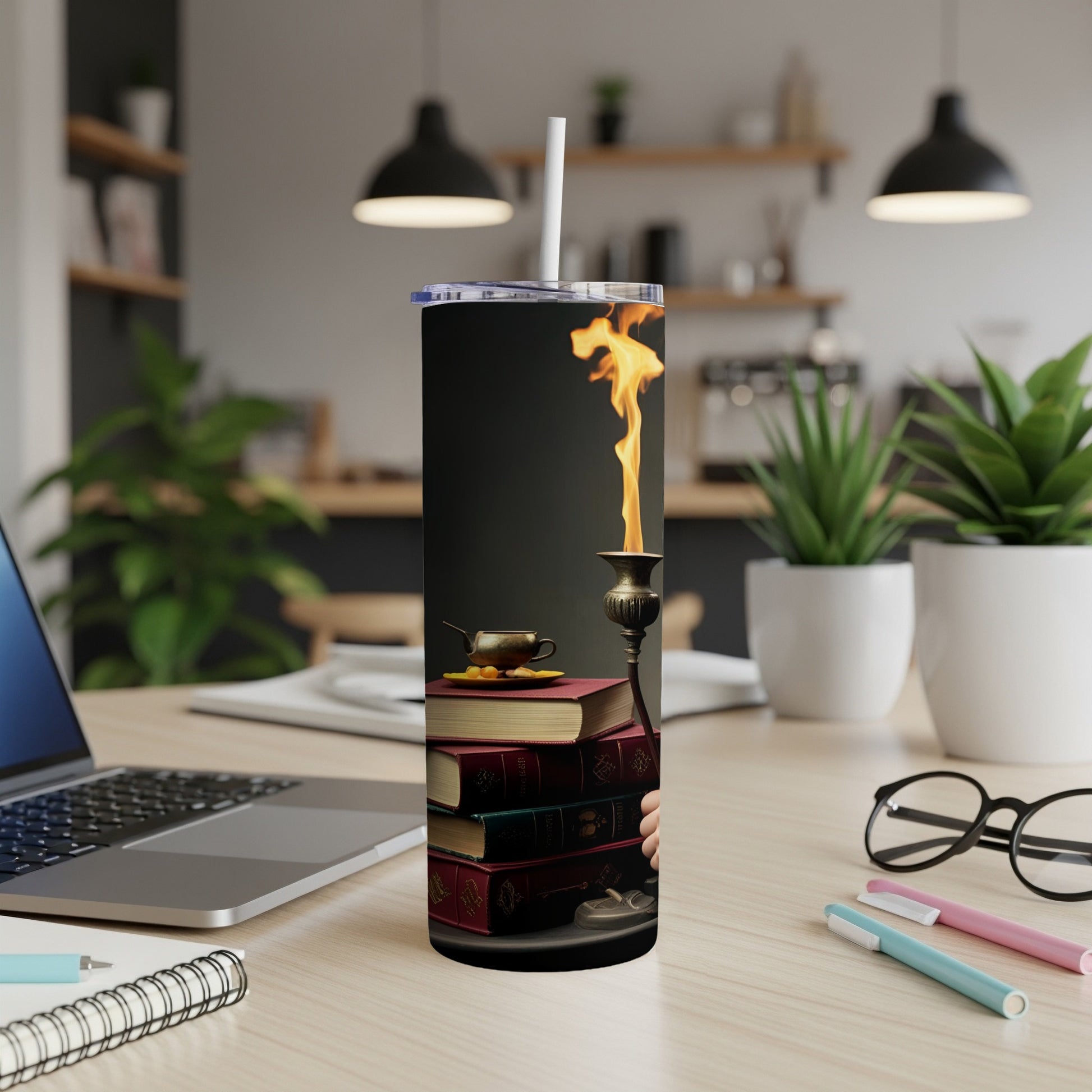 Candlestick ablaze atop stack of old books with tea cup, on a desk.