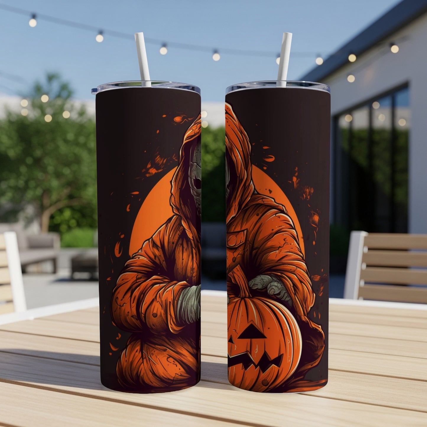 Two tumblers with Halloween art featuring a hooded figure holding a jack-o'-lantern.