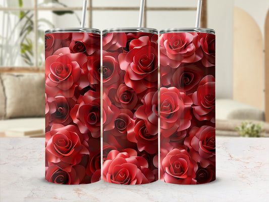 Three red rose pattern tumblers with straws on a marble surface.
