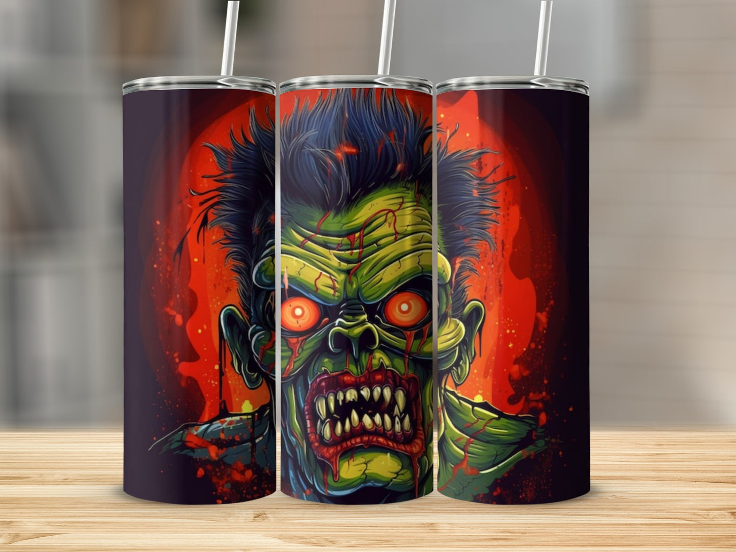 Three tumblers feature a close-up of a green zombie face with glowing red eyes and sharp teeth.